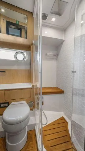  Yacht Photos Pics Modern bathroom in 2024 OKEAN 52 yacht with wood accents and glass shower.