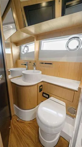 Yacht Photos Pics 2024 OKEAN 52 yacht bathroom with modern fixtures and wood accents.
