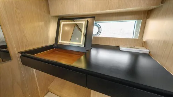  Yacht Photos Pics 2024 OKEAN 52 yacht interior with vanity mirror and sleek wooden finish.