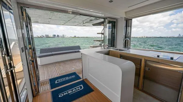  Yacht Photos Pics 2024 OKEAN 52 yacht interior with open deck, modern kitchen, and ocean view.