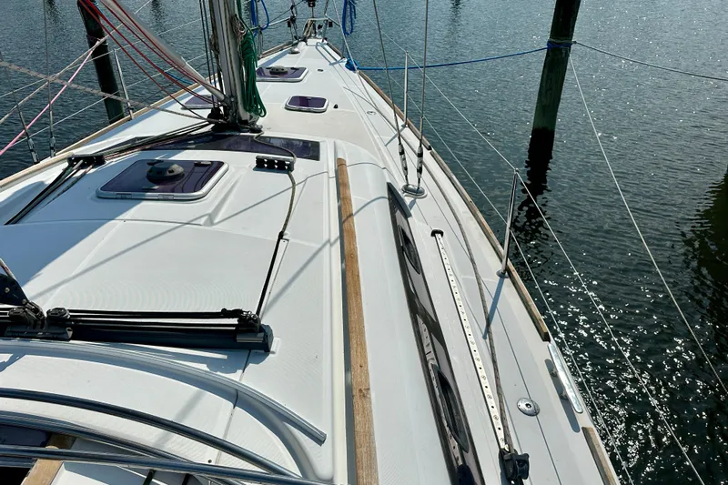  Yacht Photos Pics Deck view of 2010 Beneteau Oceanis 40 sailboat docked on calm water.