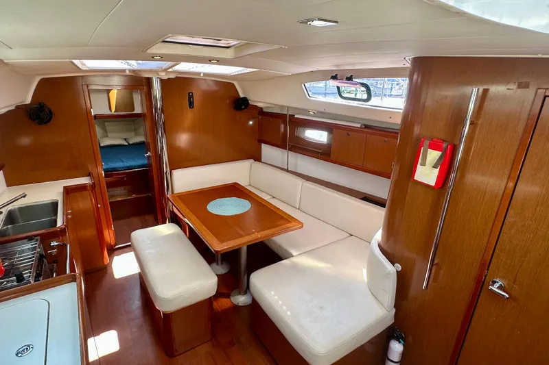  Yacht Photos Pics Interior of 2010 Beneteau Oceanis 40 yacht with cozy seating and wooden finishes.