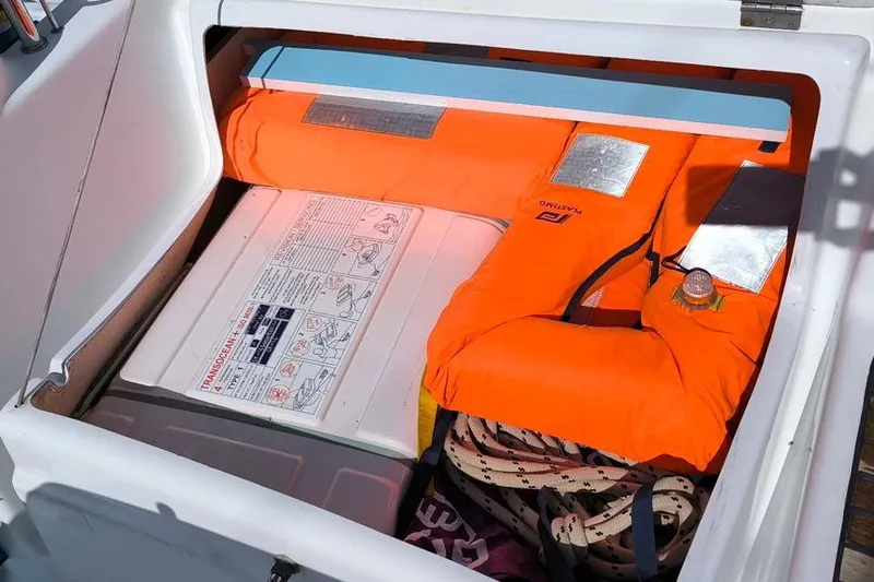  Yacht Photos Pics Storage compartment on a 2011 Beneteau Oceanis 40 with life jacket and safety equipment.