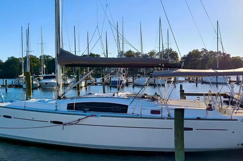 Yacht Photos Pics 2011 Beneteau Oceanis 40 sailboat docked in a marina, surrounded by other boats.