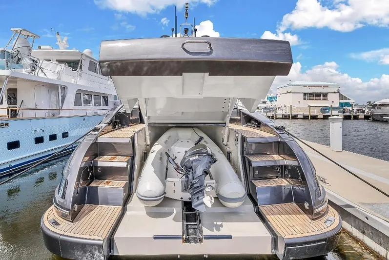 Joe Yacht Photos Pics 2015 Riva 63 Virtus yacht with open storage compartment, docked at marina under blue sky.