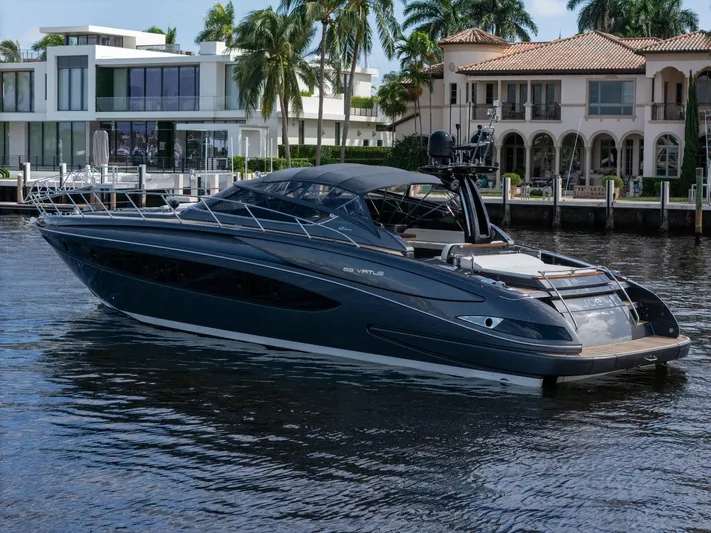 Joe Yacht Photos Pics Luxury 2015 Riva 63 Virtus yacht docked near waterfront mansions and palm trees.