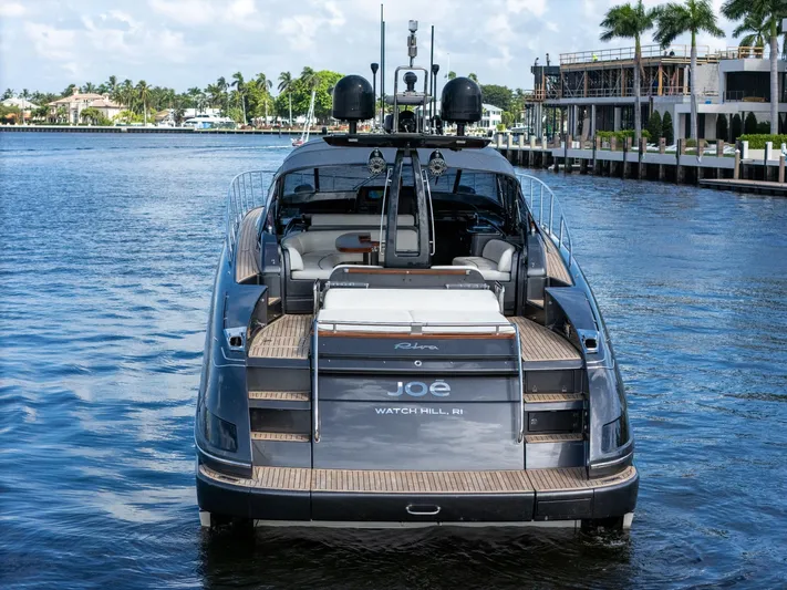 Joe Yacht Photos Pics Luxury 2015 Riva 63 Virtus yacht docked in a serene waterfront setting.