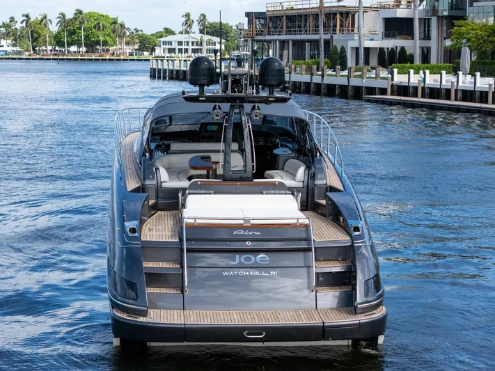 Joe Yacht Photos Pics 2015 Riva 63 Virtus luxury yacht cruising on a scenic waterfront.