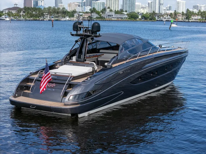 Joe Yacht Photos Pics 2015 Riva 63 Virtus luxury yacht on calm water, city skyline in background.