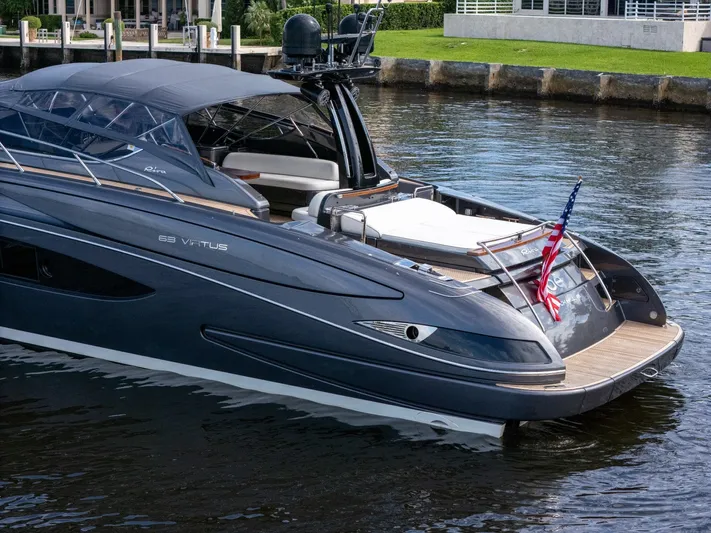 Joe Yacht Photos Pics 2015 Riva 63 Virtus luxury yacht docked, featuring sleek design and American flag.
