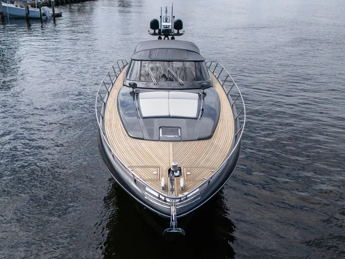 Joe Yacht Photos Pics 2015 Riva 63 Virtus luxury yacht on calm water, showcasing sleek design and wooden deck.