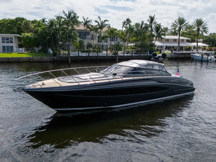 Joe Yacht Photos Pics Luxury 2015 Riva 63 Virtus yacht cruising near waterfront homes.