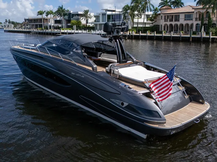 Joe Yacht Photos Pics 2015 Riva 63 Virtus luxury yacht on a sunny waterfront, displaying an American flag.