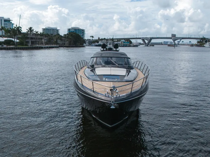 Joe Yacht Photos Pics Luxury 2015 Riva 63 Virtus yacht on calm water with cityscape background.
