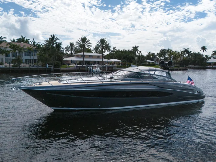Joe Yacht Photos Pics 2015 Riva 63 Virtus yacht cruising on a scenic waterway with palm trees.