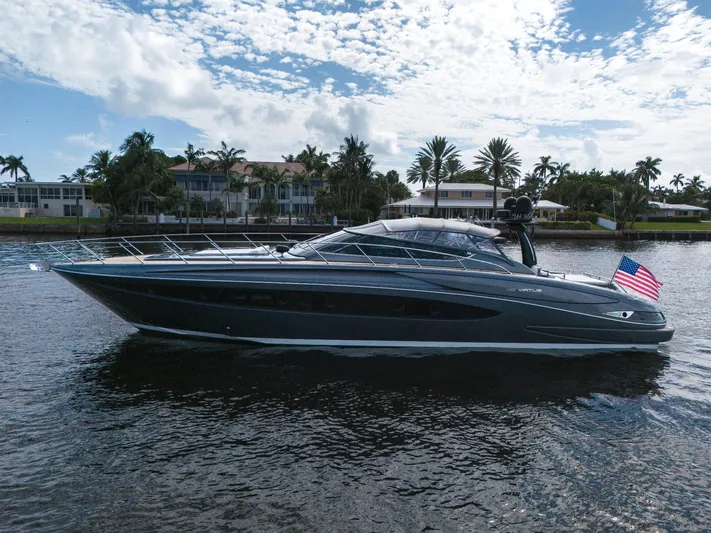 Joe Yacht Photos Pics Luxury 2015 Riva 63 Virtus yacht cruising on a scenic waterway with palm trees.