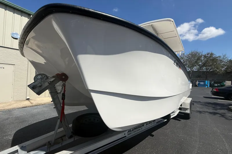  Yacht Photos Pics 2019 Calcutta 263 boat on trailer, parked outdoors under clear sky.