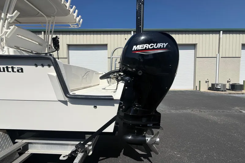  Yacht Photos Pics 2019 Calcutta 263 boat with Mercury outboard motor in a sunny industrial setting.