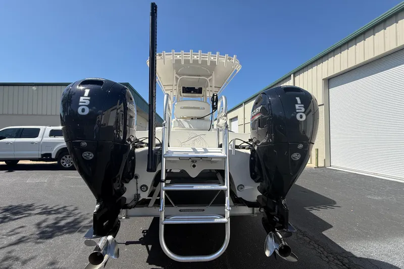  Yacht Photos Pics 2019 Calcutta 263 boat with dual Mercury 150 engines, parked outdoors.