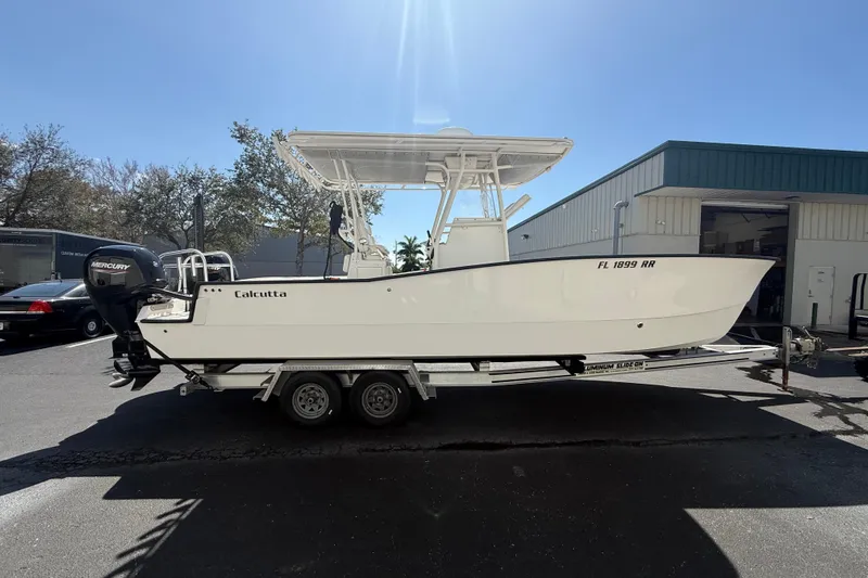  Yacht Photos Pics 2019 Calcutta 263 boat on trailer, parked outdoors under clear sky.