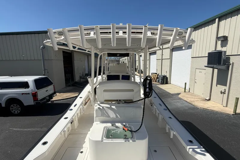  Yacht Photos Pics 2019 Calcutta 263 boat with T-top, docked near industrial buildings.