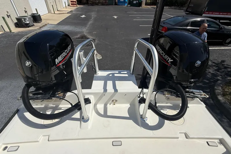  Yacht Photos Pics Twin Mercury outboard engines on a 2019 Calcutta 263 boat in a parking lot.