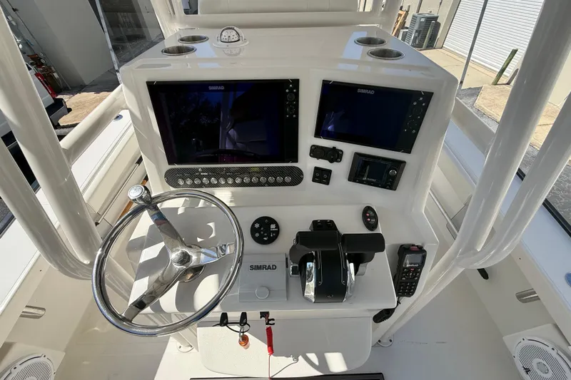  Yacht Photos Pics 2019 Calcutta 263 boat dashboard with dual Simrad displays and steering wheel.