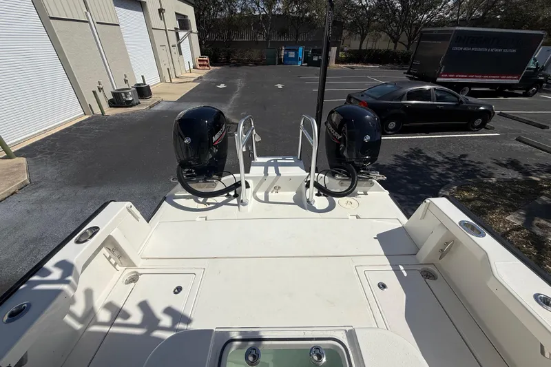  Yacht Photos Pics 2019 Calcutta 263 boat with dual Mercury engines in a parking lot.
