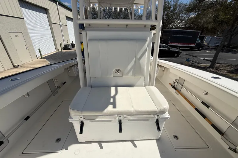  Yacht Photos Pics 2019 Calcutta 263 boat interior with white seating and storage, parked outdoors.