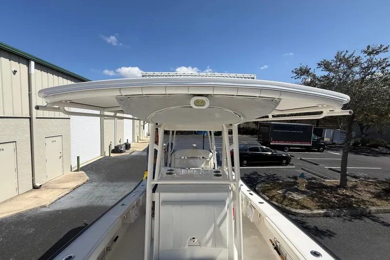  Yacht Photos Pics 2019 Calcutta 263 boat with T-top, parked near industrial buildings.