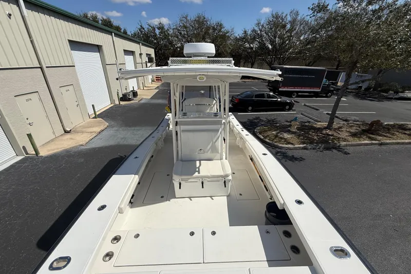  Yacht Photos Pics 2019 Calcutta 263 boat docked near industrial buildings, sunny day.
