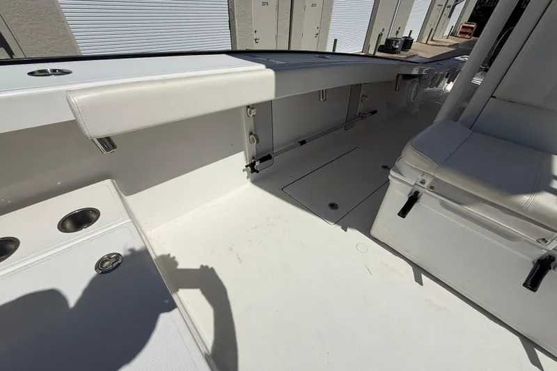  Yacht Photos Pics Interior of a 2019 Calcutta 263 boat, featuring white seating and storage compartments.