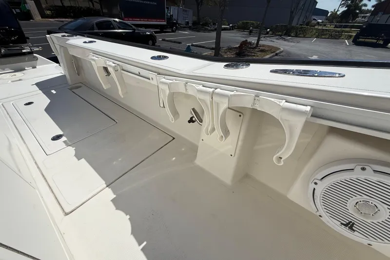  Yacht Photos Pics 2019 Calcutta 263 boat interior with rod holders and speaker in a parking lot.