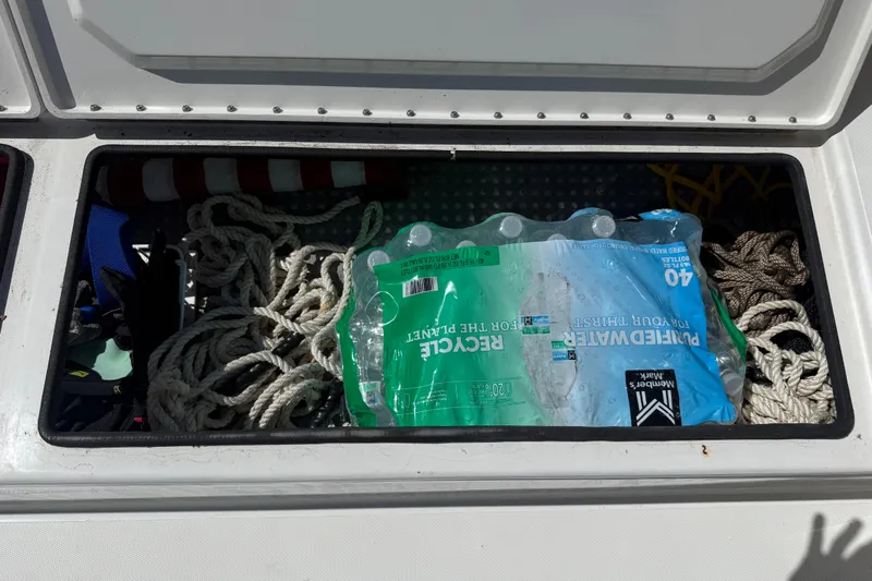 Yacht Photos Pics Storage compartment with ropes and bottled water in a 2019 Calcutta 263 boat.