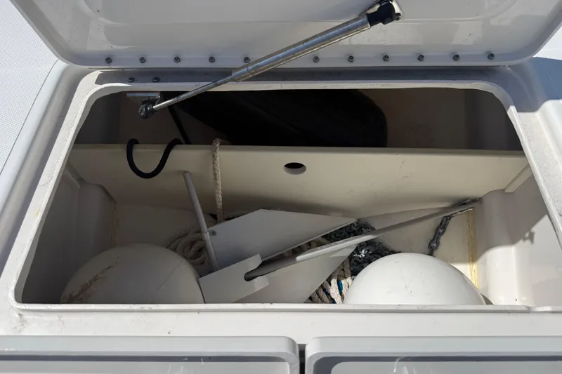  Yacht Photos Pics Open storage compartment on Calcutta 263 boat, containing anchor, ropes, and buoys.