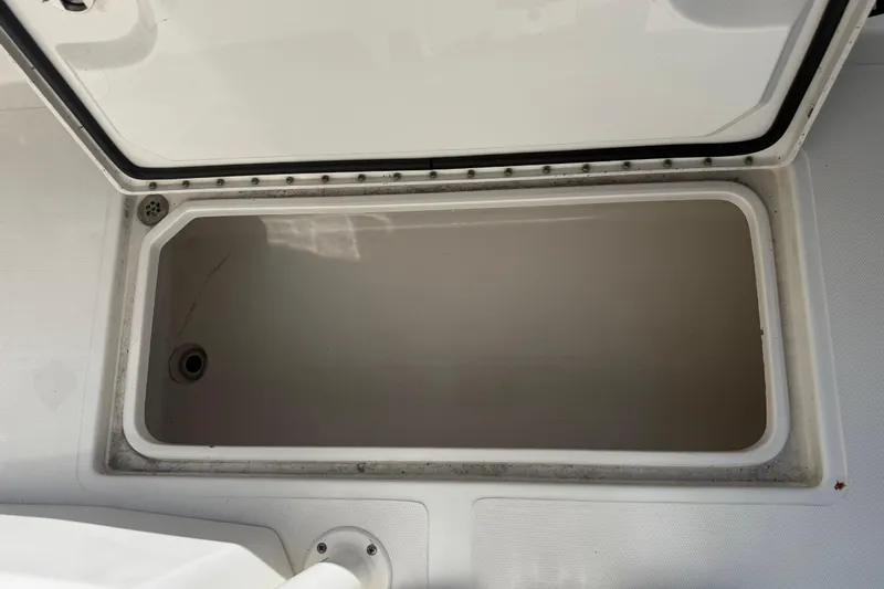  Yacht Photos Pics Open storage compartment on 2019 Calcutta 263 boat, showing interior space.