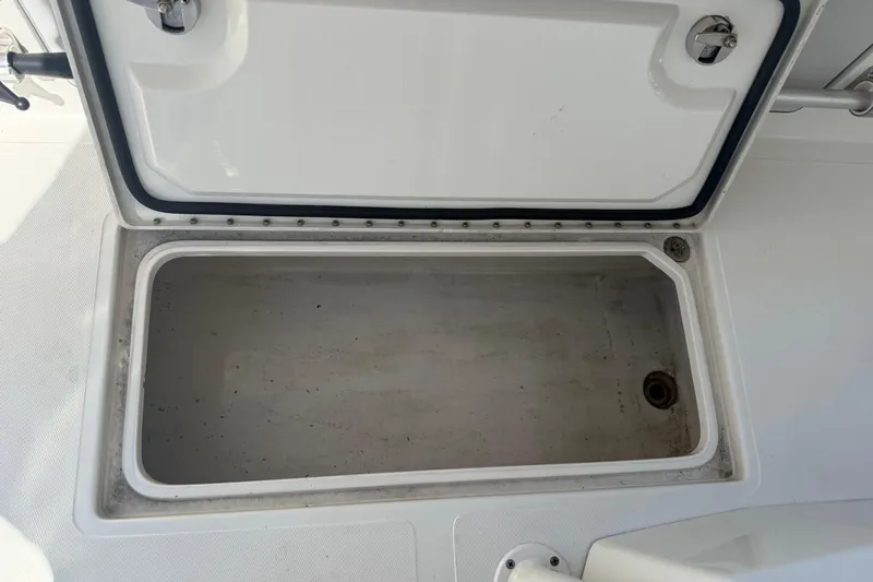  Yacht Photos Pics Open storage compartment on a 2019 Calcutta 263 boat, showing interior space.