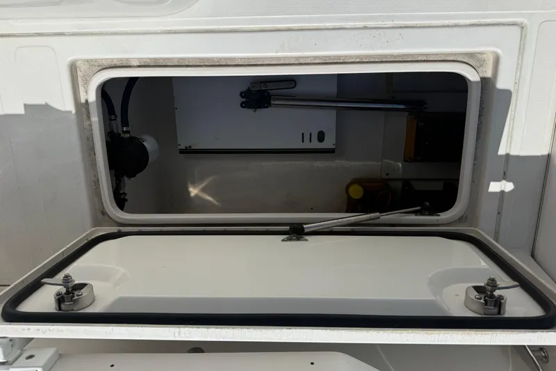  Yacht Photos Pics Open storage compartment on a 2019 Calcutta 263 boat, showing interior details.