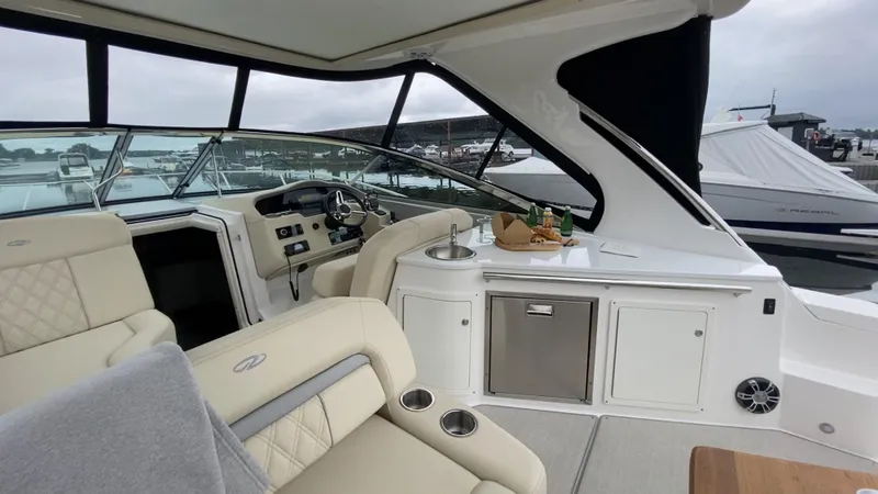  Yacht Photos Pics Luxurious interior of 2021 Regal 33 Express yacht with seating and kitchenette.