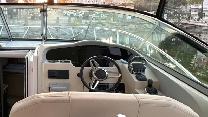  Yacht Photos Pics 2021 Regal 33 Express boat helm with steering wheel and navigation controls.