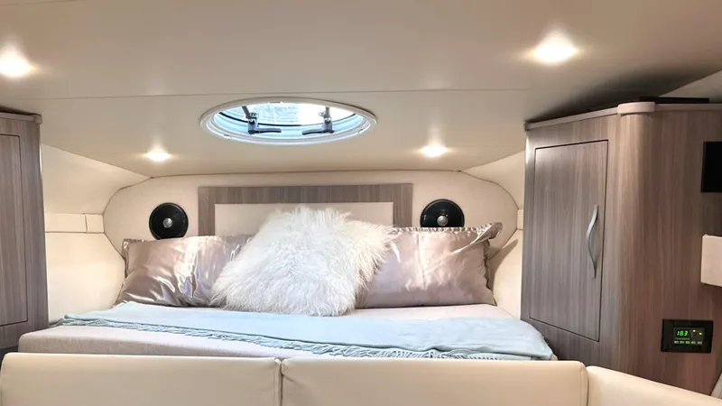  Yacht Photos Pics Luxurious cabin interior of 2021 Regal 33 Express yacht with cozy bedding and modern lighting.