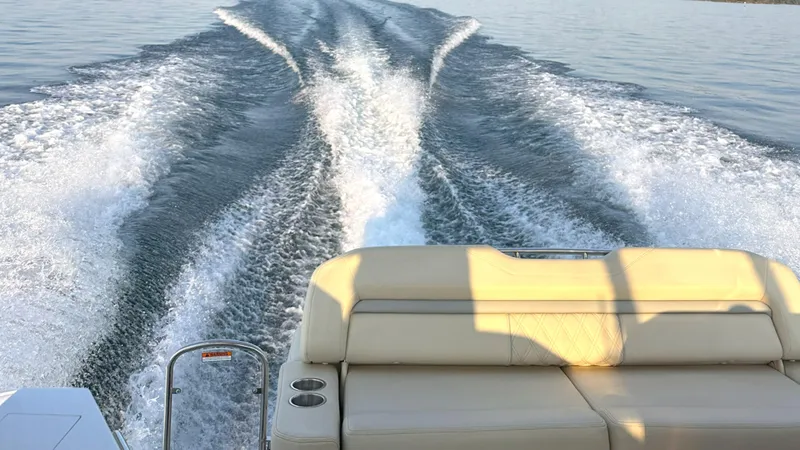  Yacht Photos Pics Wake behind a 2021 Regal 33 Express boat on calm water.