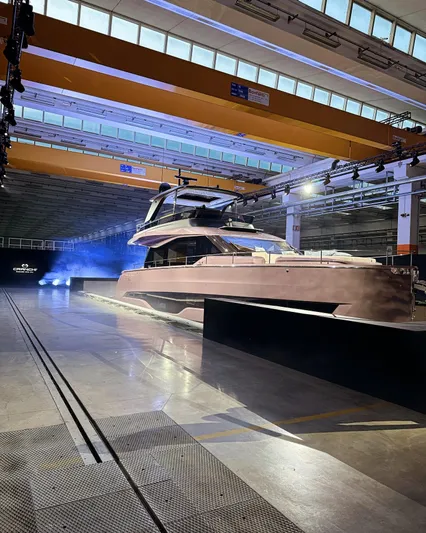  Yacht Photos Pics 2025 Cranchi Sessantadue 62 yacht showcased in a modern indoor facility.
