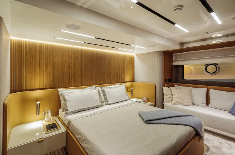  Yacht Photos Pics Luxurious bedroom interior of 2025 Cranchi Sessantadue 62 yacht with modern design and cozy ambiance.