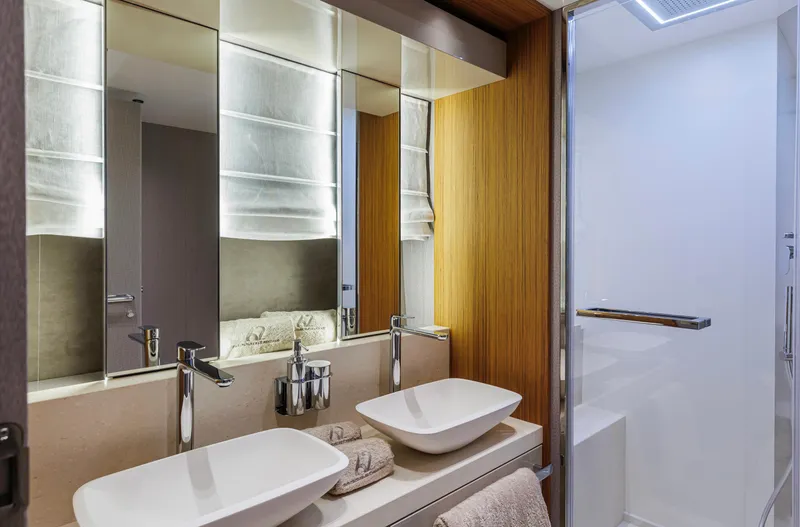  Yacht Photos Pics Luxurious bathroom in 2025 Cranchi Sessantadue 62 yacht with modern fixtures and dual sinks.