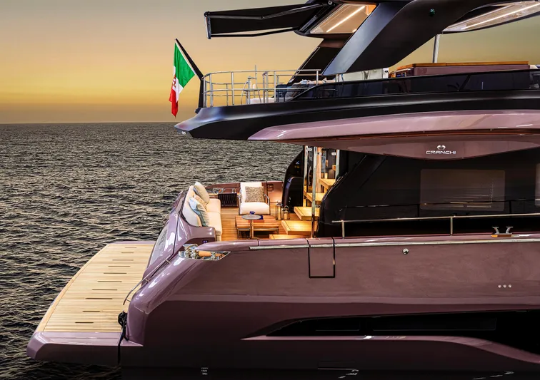  Yacht Photos Pics 2025 Cranchi Sessantadue 62 yacht at sunset, featuring elegant design and Italian flag.
