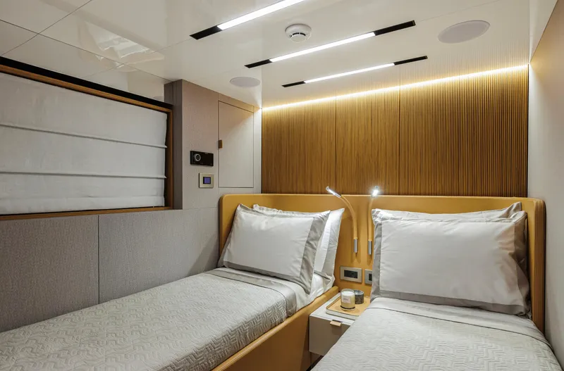  Yacht Photos Pics Luxurious twin cabin in 2025 Cranchi Sessantadue 62 yacht, featuring modern design and ambient lighting.