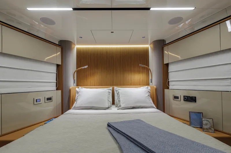  Yacht Photos Pics Luxurious bedroom interior of 2025 Cranchi Sessantadue 62 yacht with modern design elements.