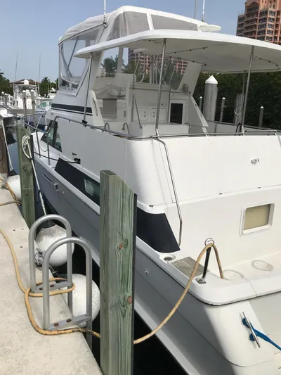  Yacht Photos Pics 1994 Hatteras 42 Cockpit Motor Yacht docked at marina, side view.