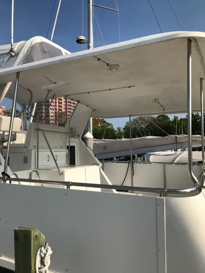  Yacht Photos Pics 1994 Hatteras 42 Cockpit Motor Yacht docked, featuring spacious deck and canopy.